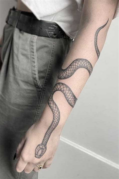 Snake wrapping around arm tattoo